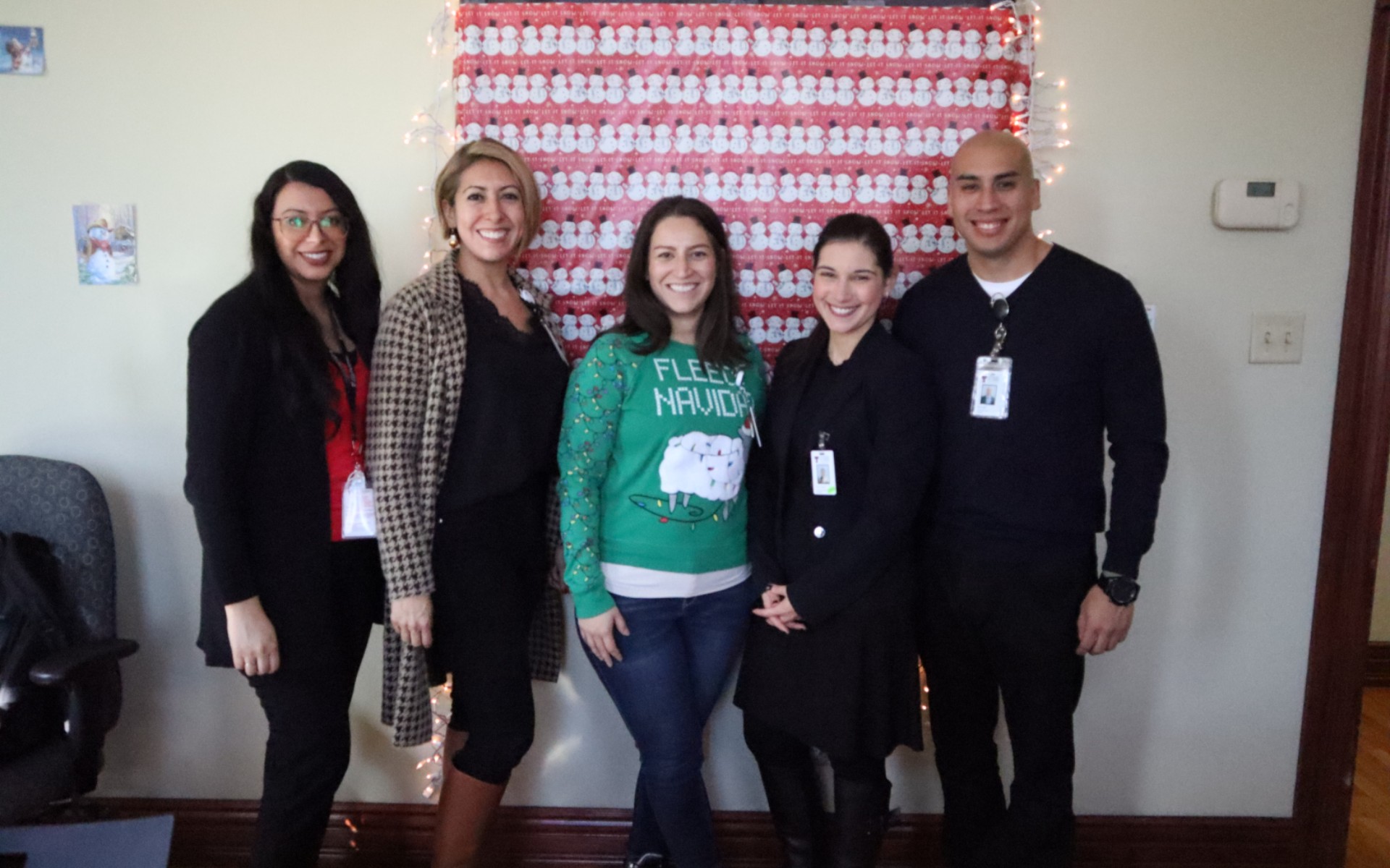 Psychology faculty and trainees posing together during a holiday celebration.